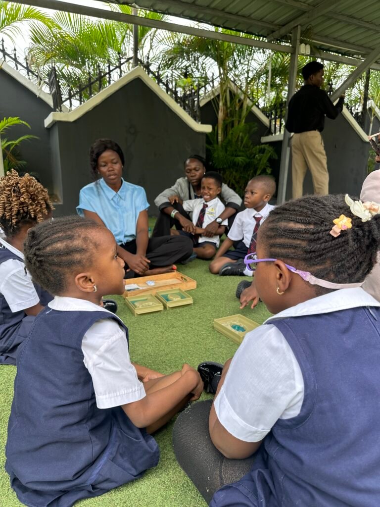 A teacher leading small groups of pupils working with wooden learning materials on the lawn