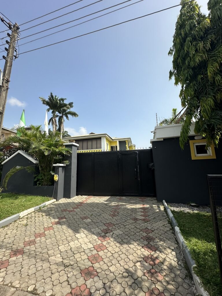 The school entrance gate and paved driveway