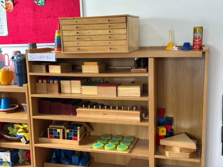 Montessori learning materials arranged on low wooden shelves
