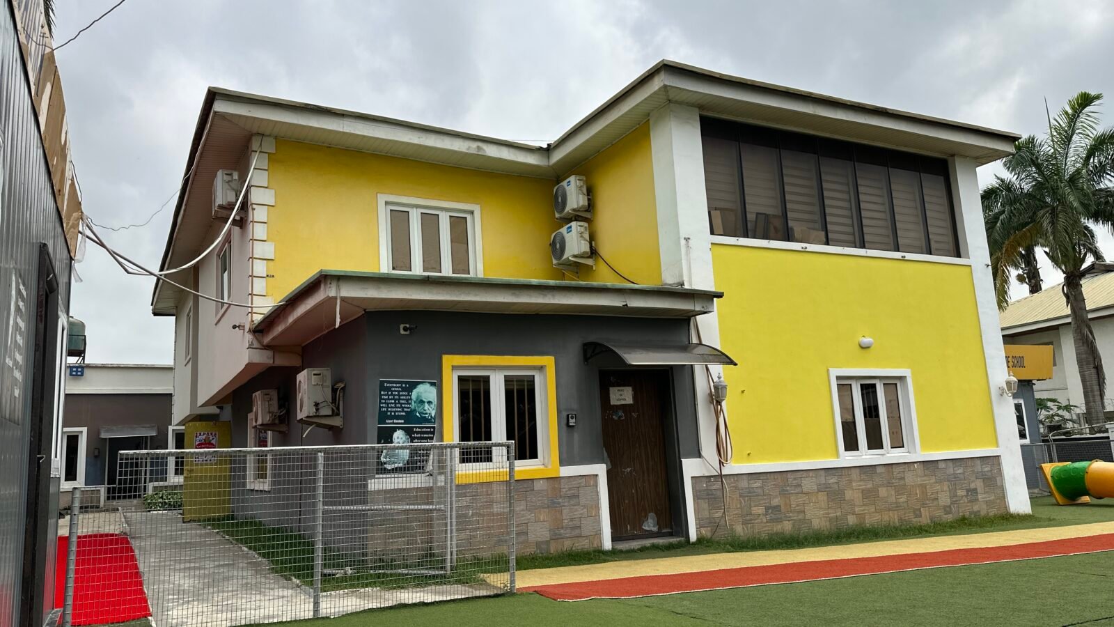 The yellow school building and its lawn