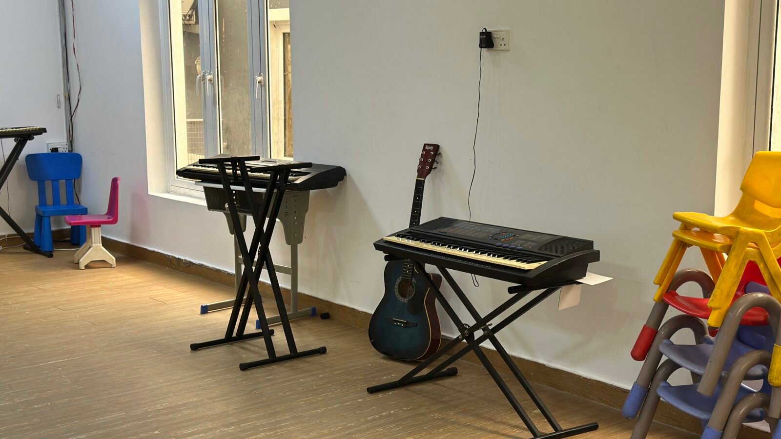 The music room with electronic keyboards and a guitar